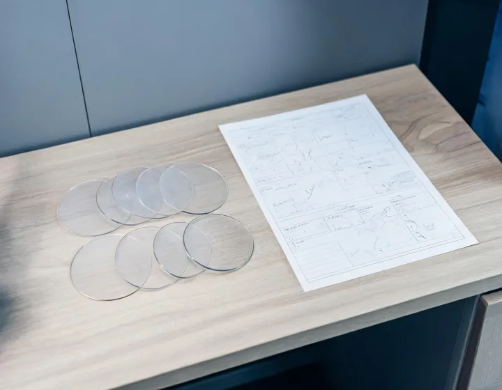 Unlabeled progressive glasses beside a written procurement brief